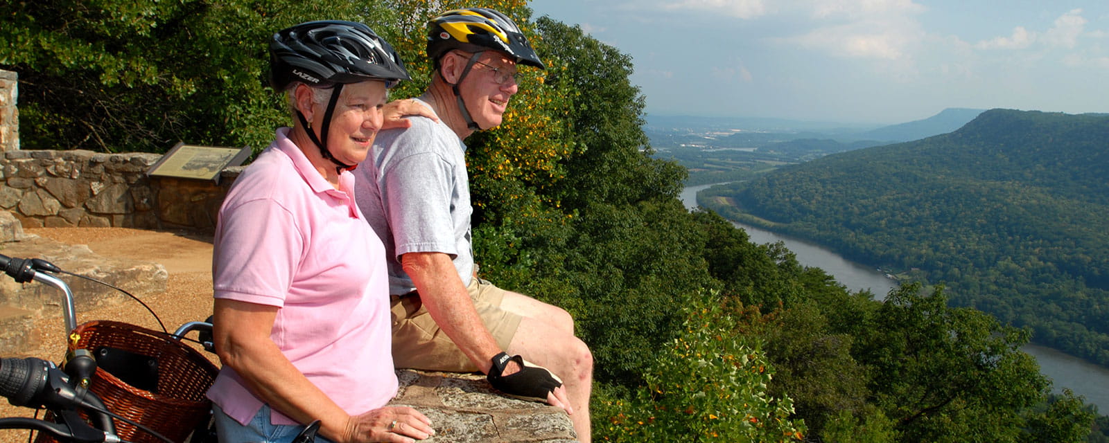 Senior couple riding bikes, look out over signal mounts down the road from Alexian Village Tennessee