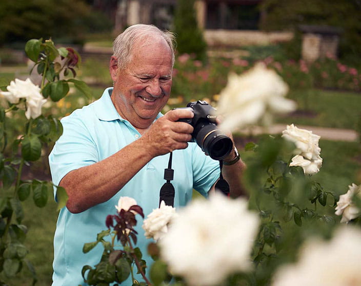 resident taking photos of flowers at alexian village Milwaukee