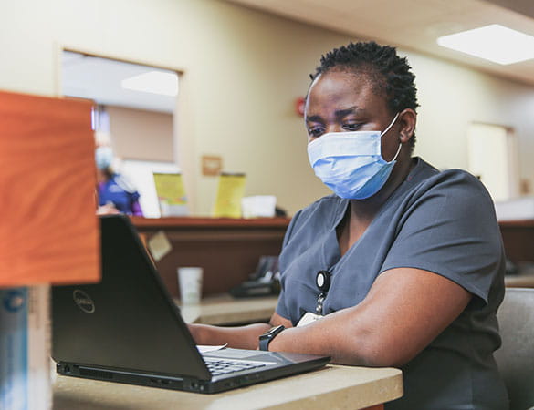 Nurse behind laptop